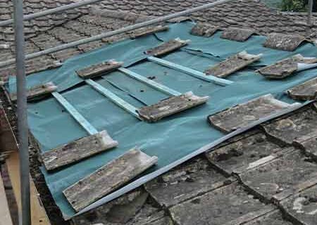 Damaged roof tiles being repaired