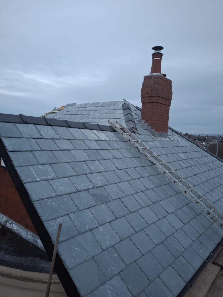 New slate roof with a brick chimney